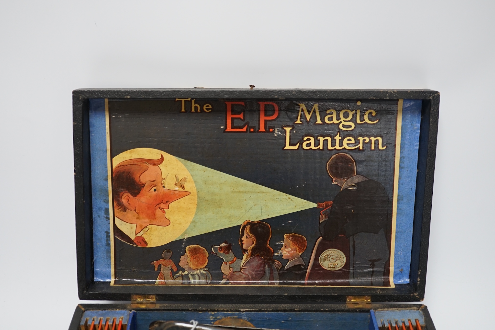 From the Studio of Fred Cuming. Vintage E.P. magic lantern and slides, cased. Condition - fair